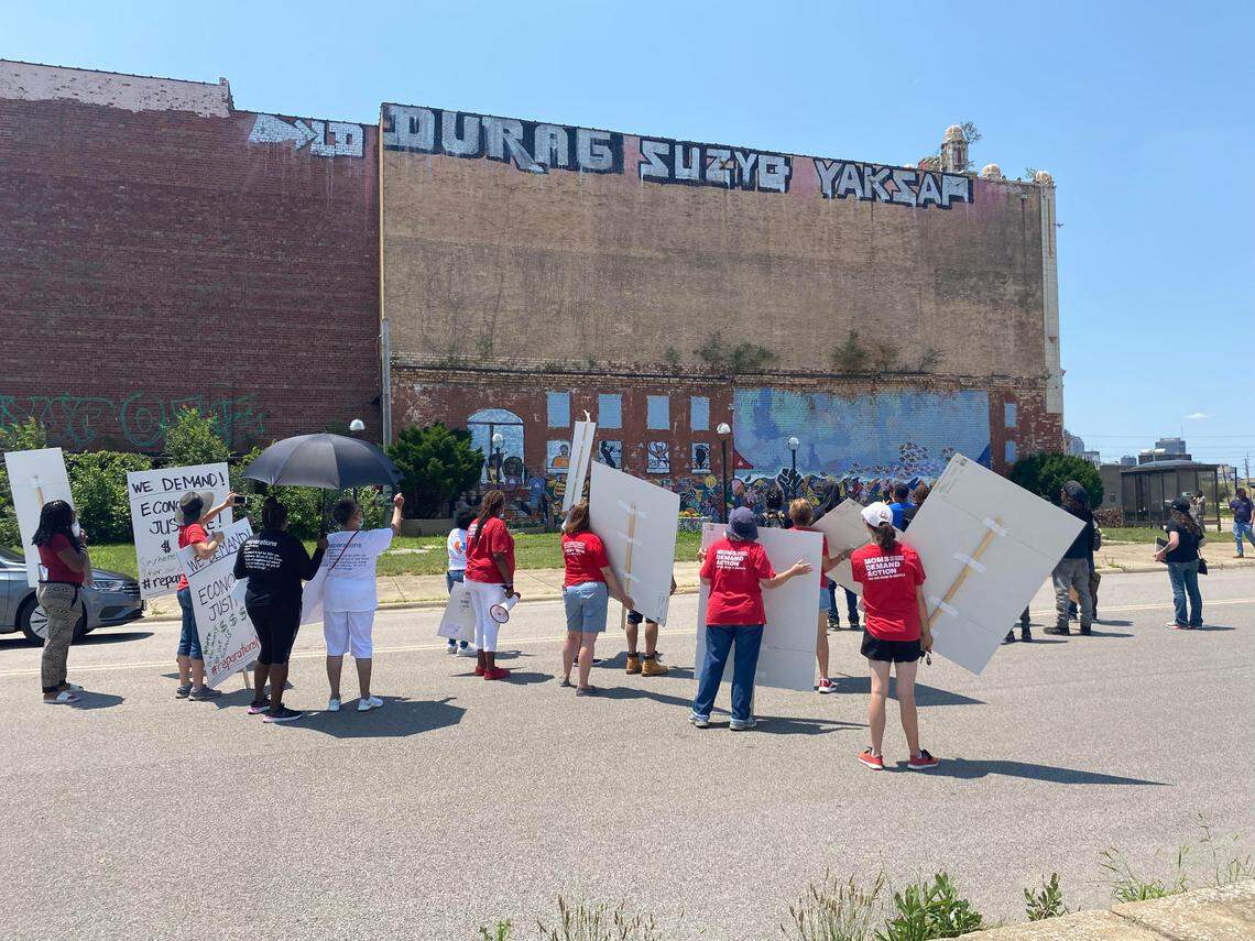 Protesters rallying for reparations for the East St. Louis 1917 Massacre pause for a moment at the Majestic Theater on Collinsville Ave., on July 3, 2021.