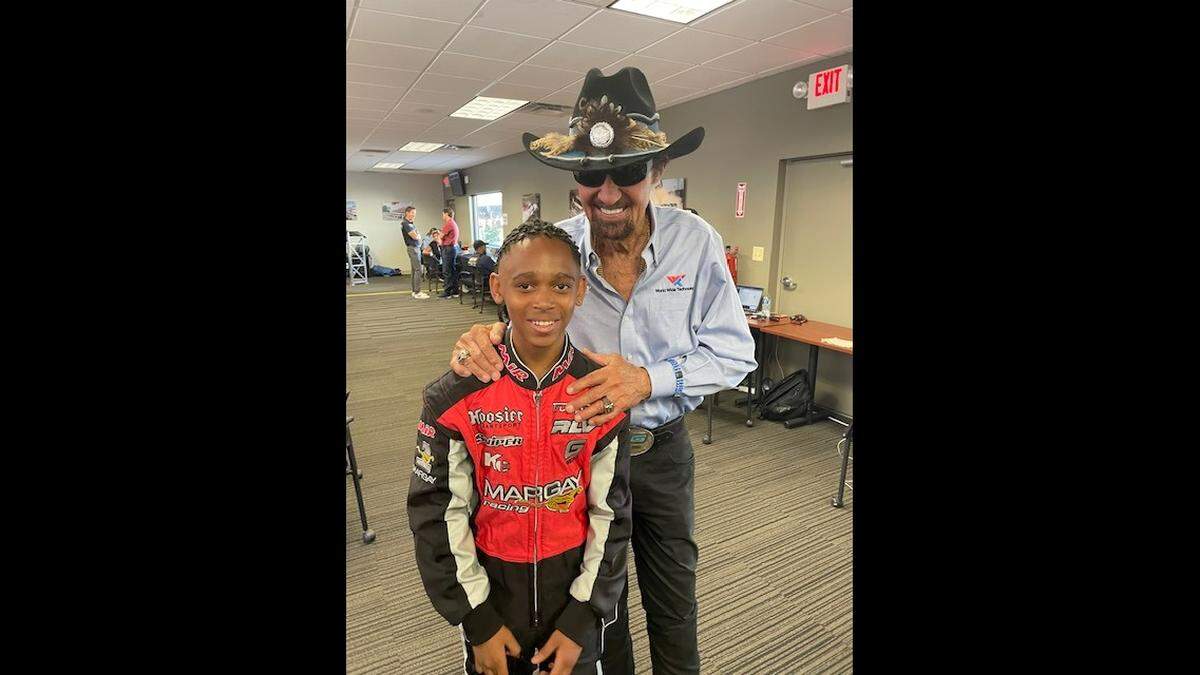 Josiah Unaeze, 12, poses with NASCAR star Richard “The King” Petty during a pre-race event for the Enjoy Illinois 300 race at World Wide Technology Raceway in Madison. Josiah is the winner of the inaugural Ignite Scholarship awarded by Raceway Gives Foundation, the charitable arm of the track.
