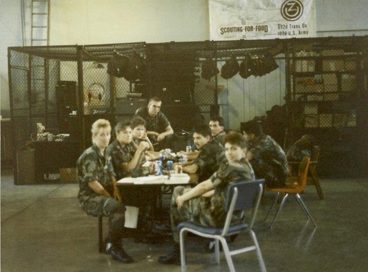 U.S. Army reservists in the 657th Transportation Detachment gather in 1991 in a warehouse area of the Pfc. Raymond Gantner Army Reserve Center in Belleville. The former Lori Lennon, now Elliott, is seated at left.