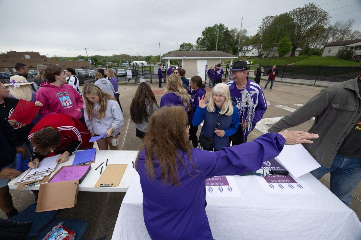 Dianne Turek helps locals sign a petition in opposition of a bill thta would ban Native American mascots in Illinois.