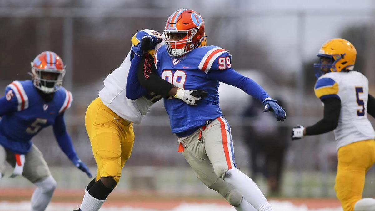 East St. Louis defensive end Keandre McClendon rushes the passer during the IHSA Class 6A quarterfinals against Crete-Monee.