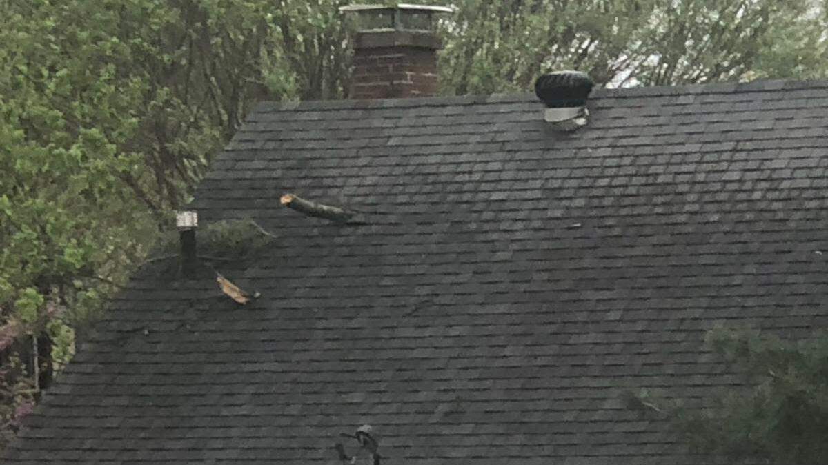 Damage to roof of house on Lebanon Avenue in Belleville following severe storms on Saturday, April 15, 2023.