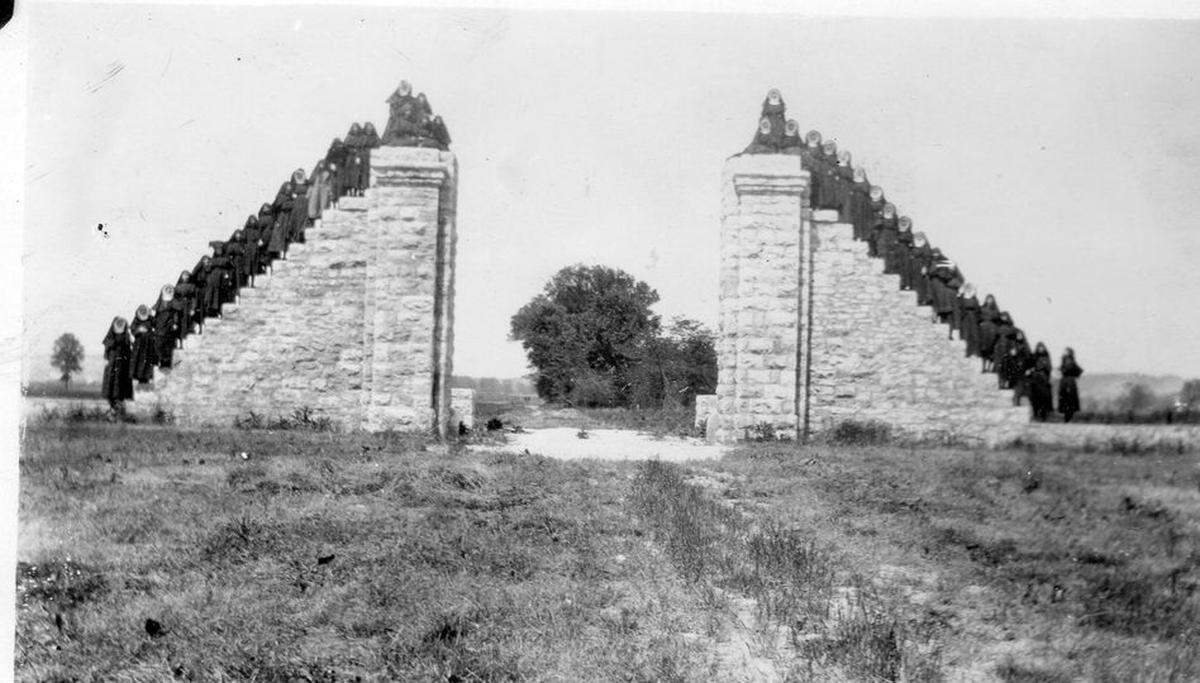 More than 50 nuns, novices and candidates with the Adorers of the Blood of Christ pose on stone gates at Fort de Chartres State Historic Site in Prairie du Rocher during a 1921 road trip.