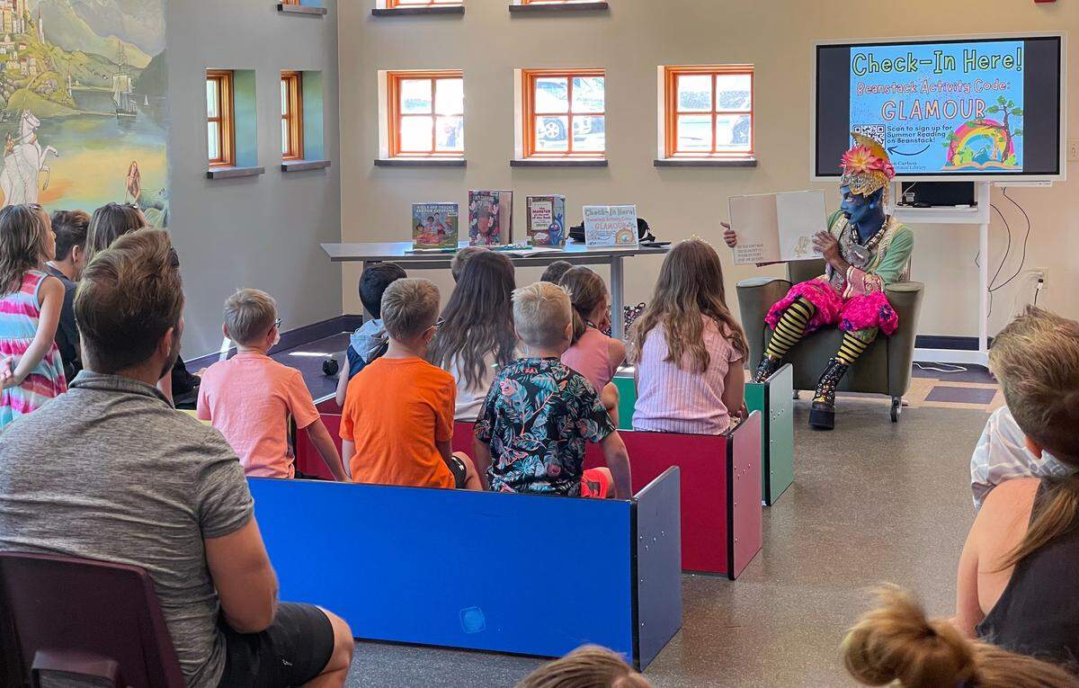 Drag performer Maxi Glamour reads “Leonardo the Terrible Monster,” a book about friendship, to a group of more than 20 children during the drag queen storytime event June 21, 2022, at the Glen Carbon Centennial Library.