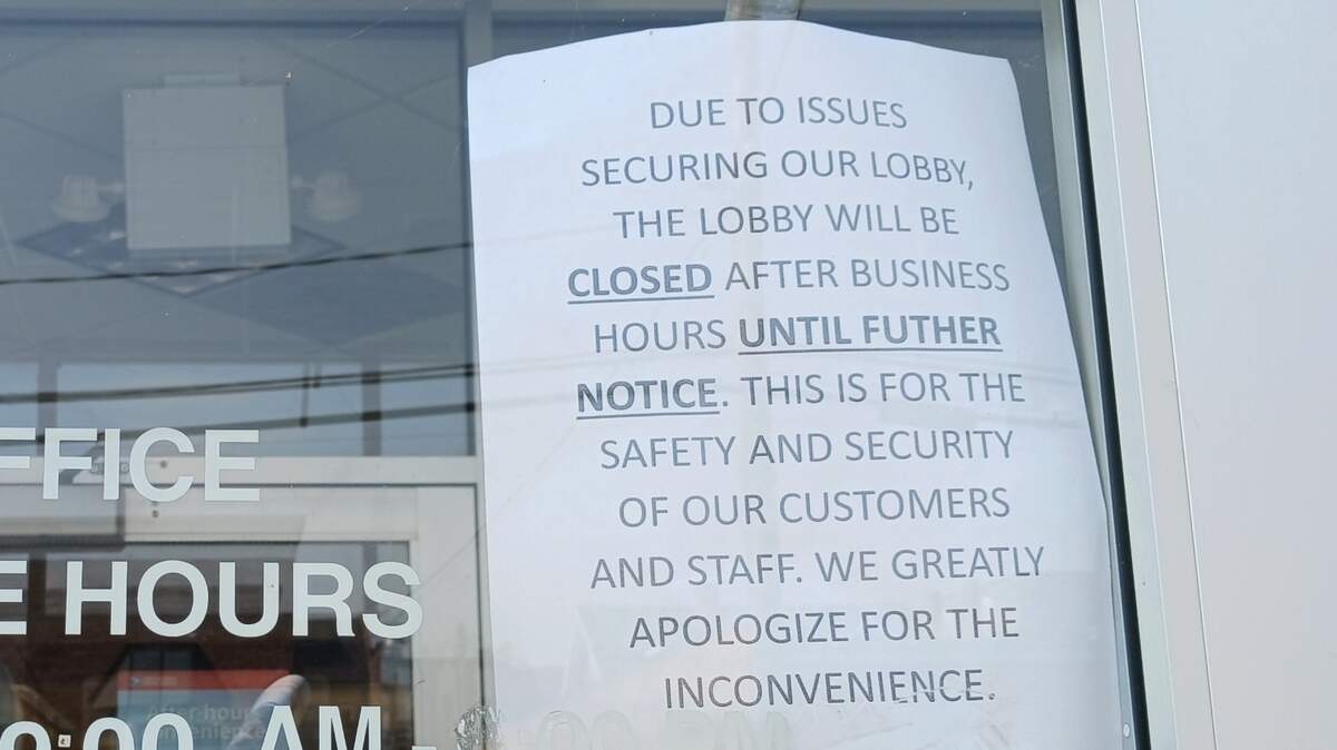 A sign on the glass door of the Belleville Post Office alerts customers to the temporary closing of the lobby after hours.