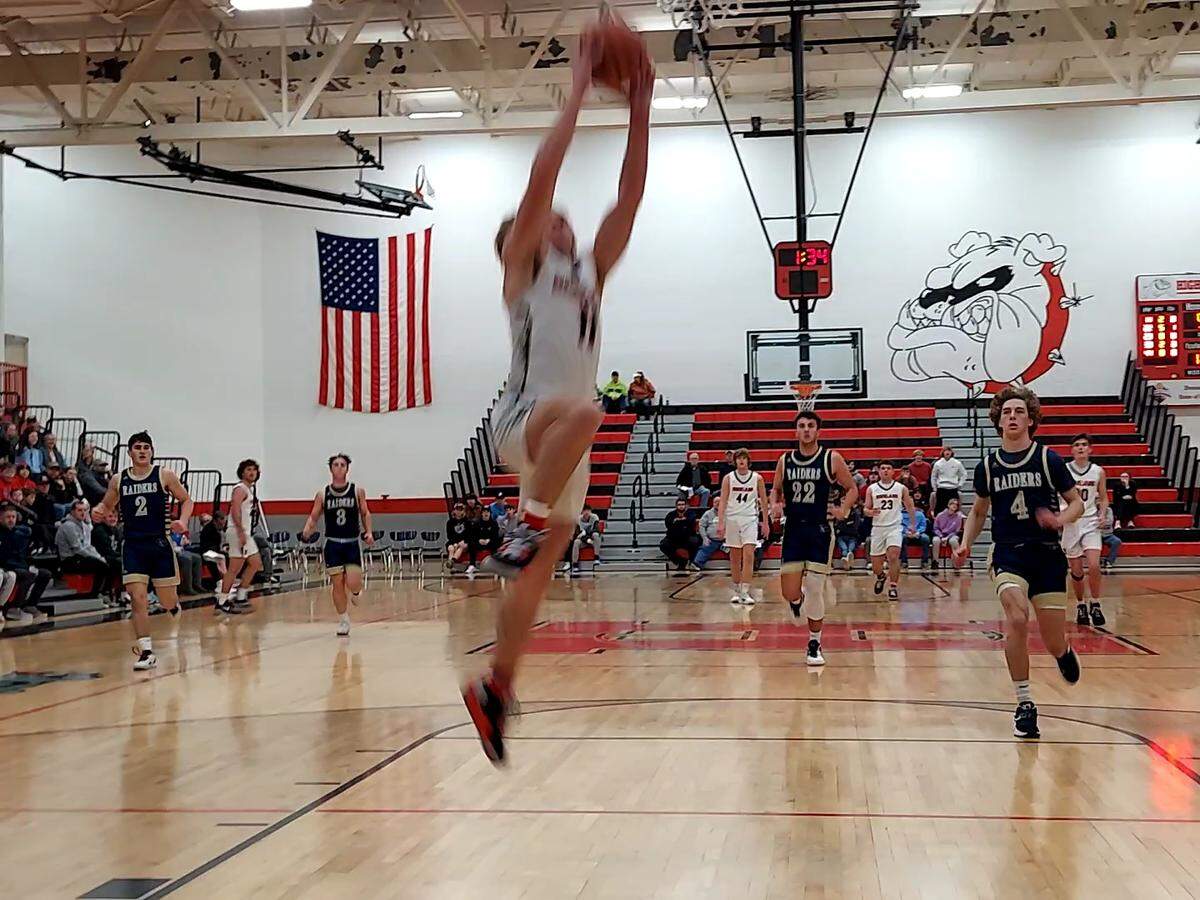 Highland’s Jake Ottensmeier rises to the basket for a slam dunk against Quincy Notre Dame during the second game of the 31st annual Highland Optimist Scott Credit Union Shootout on Saturday, Jan. 7. The Bulldogs ultimately posted 56-54 victory.