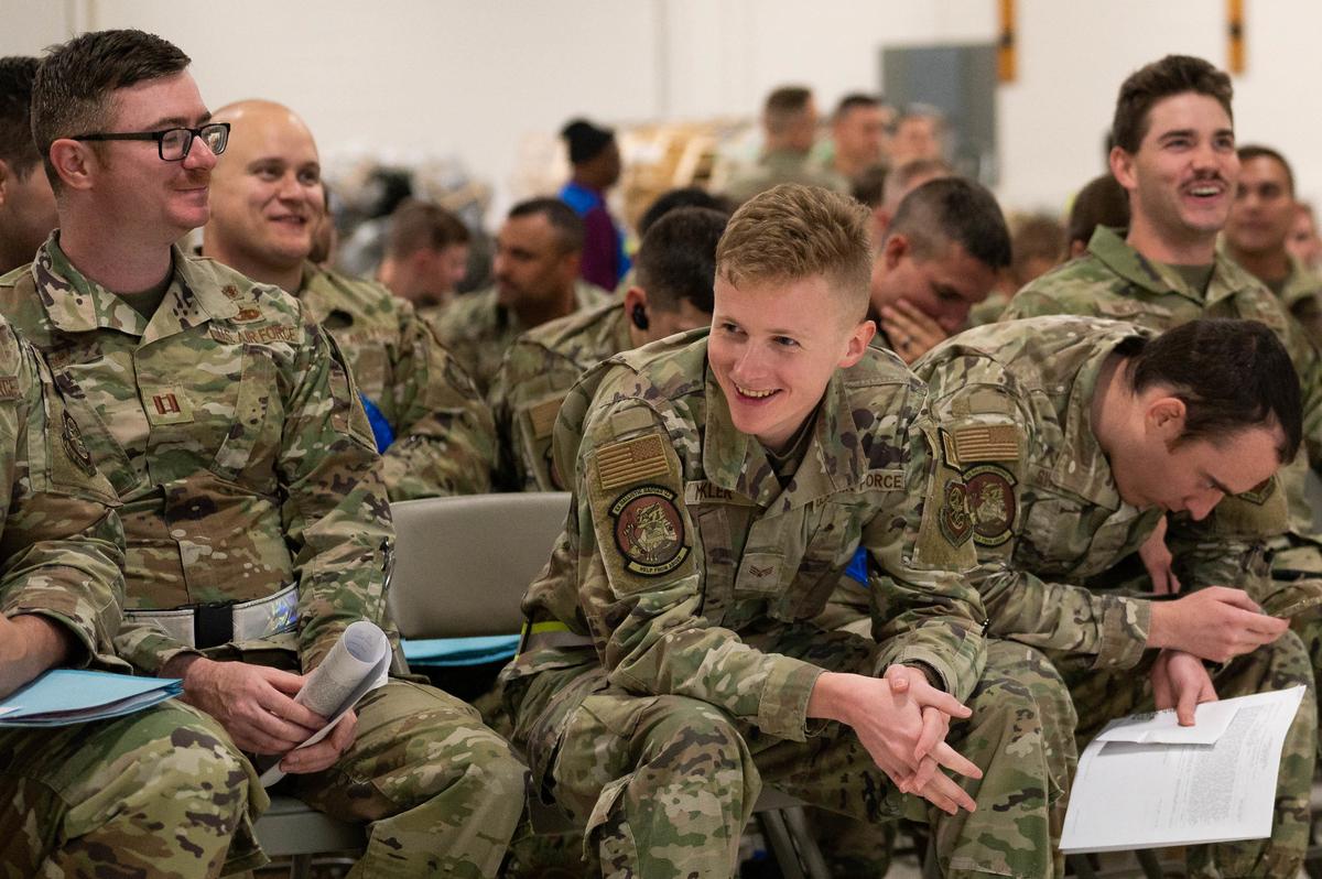 375th Air Mobility Wing Airmen laugh while waiting for a safety briefing to begin during Ballistic Badger 2022 on Volk Field Air National Guard Base, Wisconsin. BB22 is a training opportunity for Airmen at the Showcase Wing to rehearse the ability to execute rapid global mobility.
