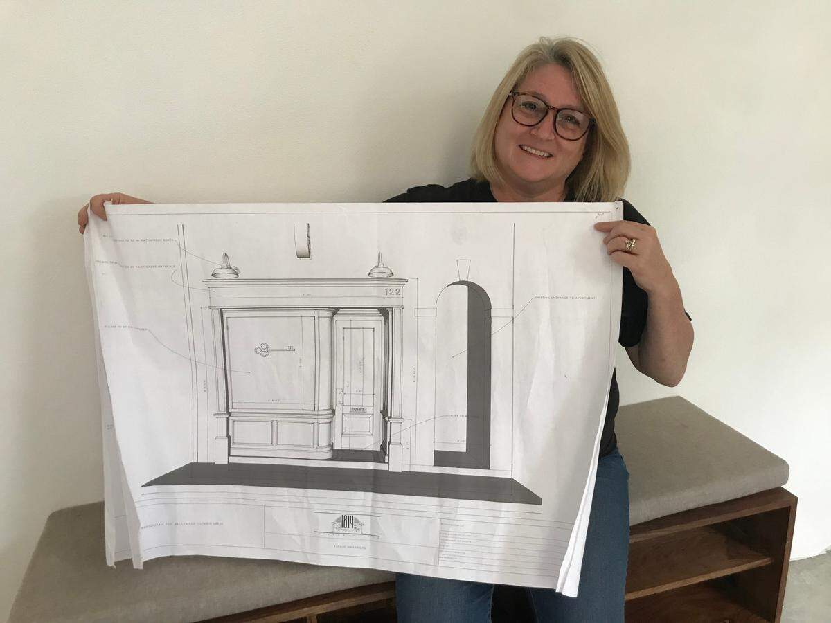 Kathy Mordini, who operates Avenue Realty with her daughter, Kinsey, holds an artist’s rendering of a facade proposed for a historic building in downtown Belleville that they would like to turn into Abend Street Incubator & Event Space.