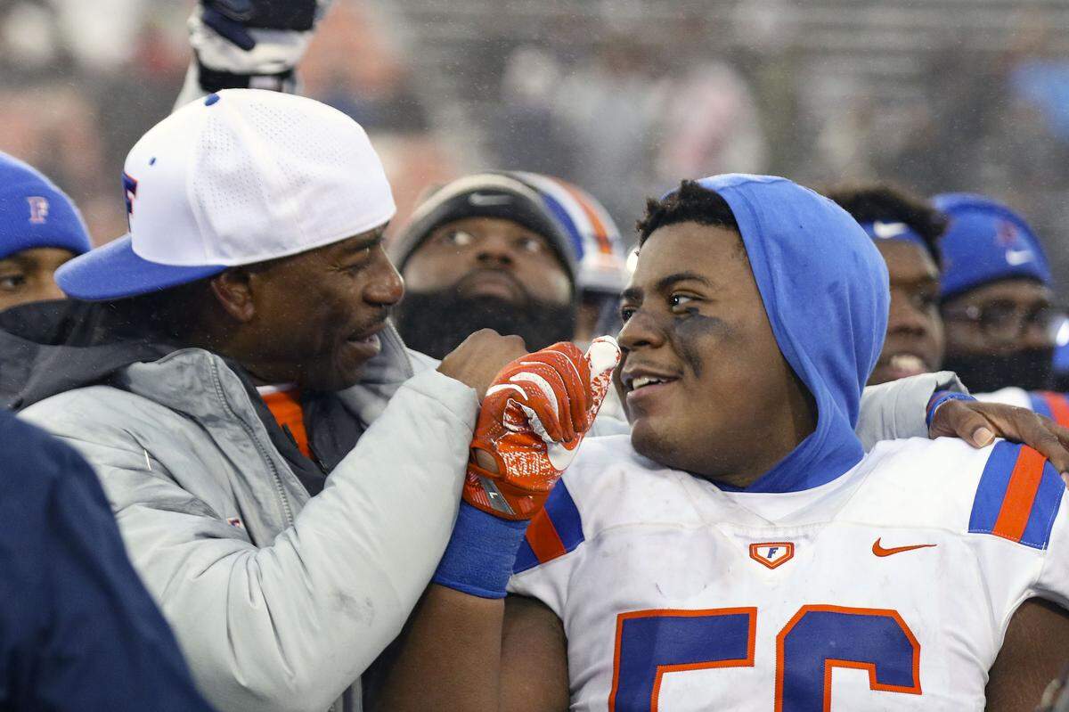 East St. Louis linebacker Kendrick Scarbrough and head coach Darren Sunkett embrace after Flyers defeated Prairie Ridge, 43-21, to win the IHSA Class 6A state championship in Dekalb in 2019. In the latest Belleville News-Democrat poll, we’re asking readers to vote on their favorite high school fall sport, with football as one of the choices.