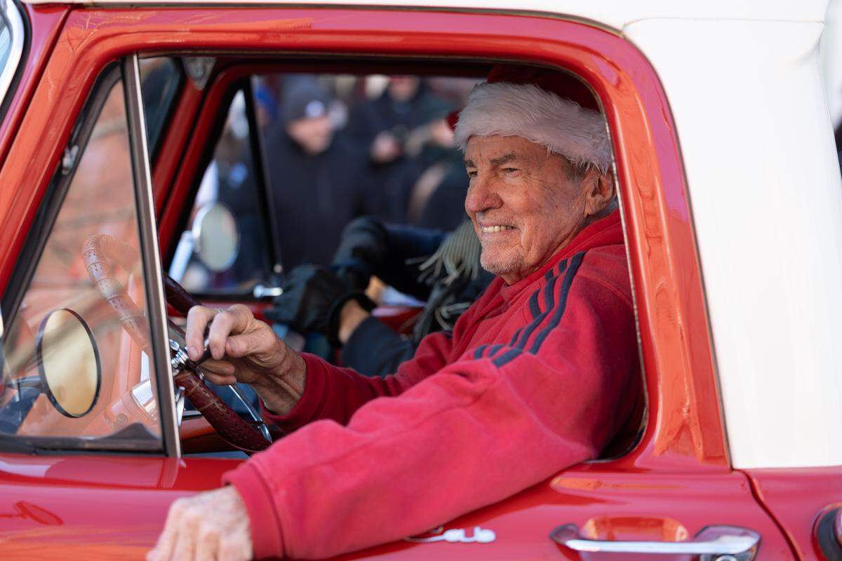 Larry Betz, president of the Belleville Historical Society, rides in an old-school truck down Belleville’s Main Street during the 2025 annual Santa Parade.