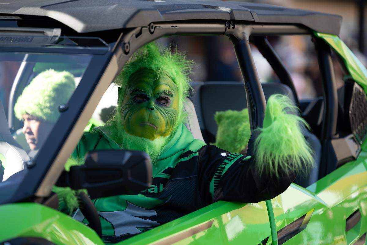 A grinch rides in the 2025 Santa Parade, presumably after his heart grew in size.
