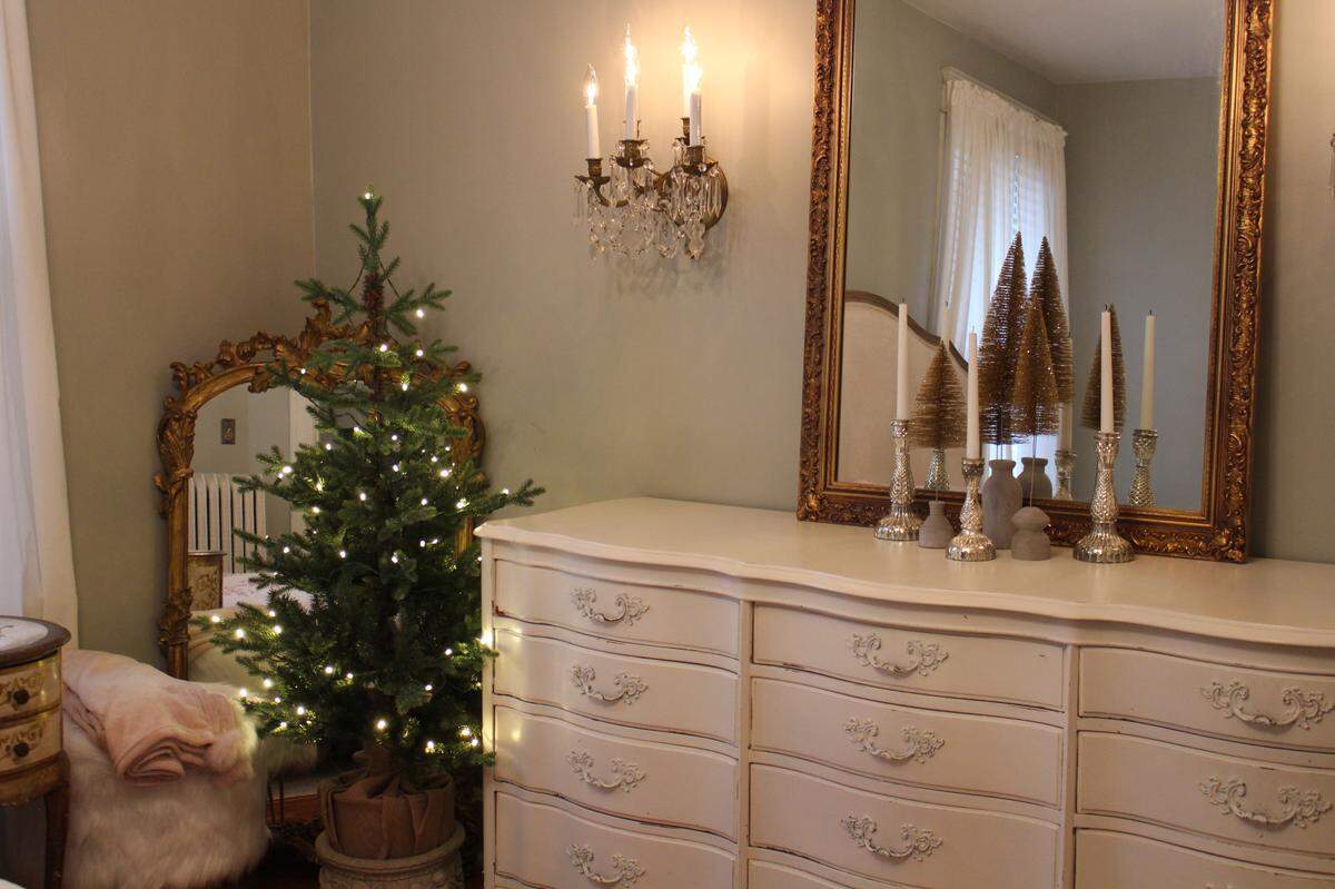 A Christmas tree with white lights stands in the corner of the master bedroom of the Hettenhausen home, which will be on Sunday’s Candlelight House Tour in Belleville.