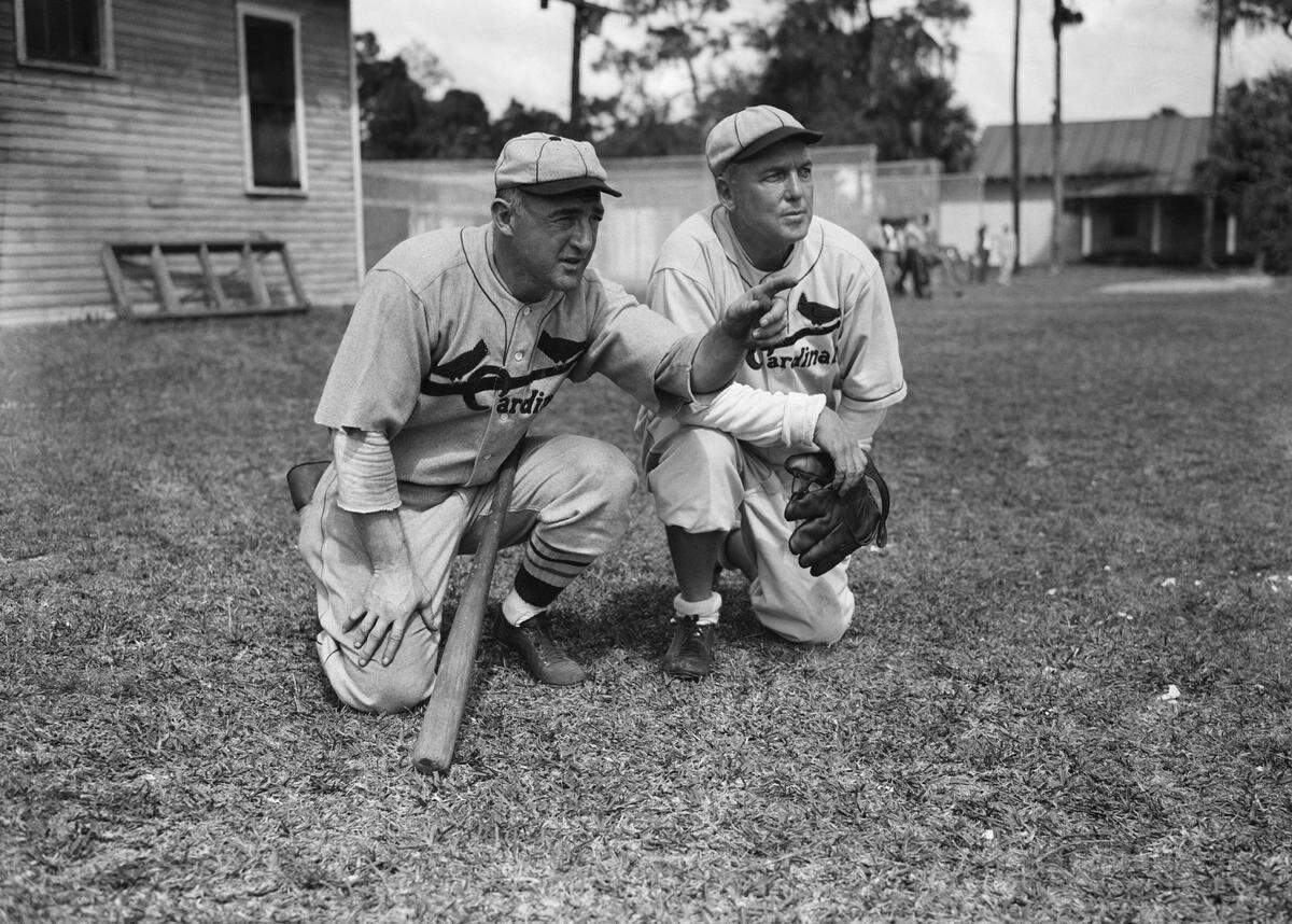 Frank Frisch, left, player-manager of the St. Louis Cardinals and Sam Breadon, owner of the club, looking over the Cardinals during their workout at the Bradenton Fla., camp on, March 10, 1934. ( AP Photo)