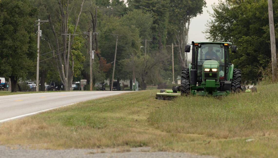 An Illinois Department of Transportation highway maintainer mows grass along Chain of Rocks Road near Granite City on Friday morning. Employees also plow snow in the winter.