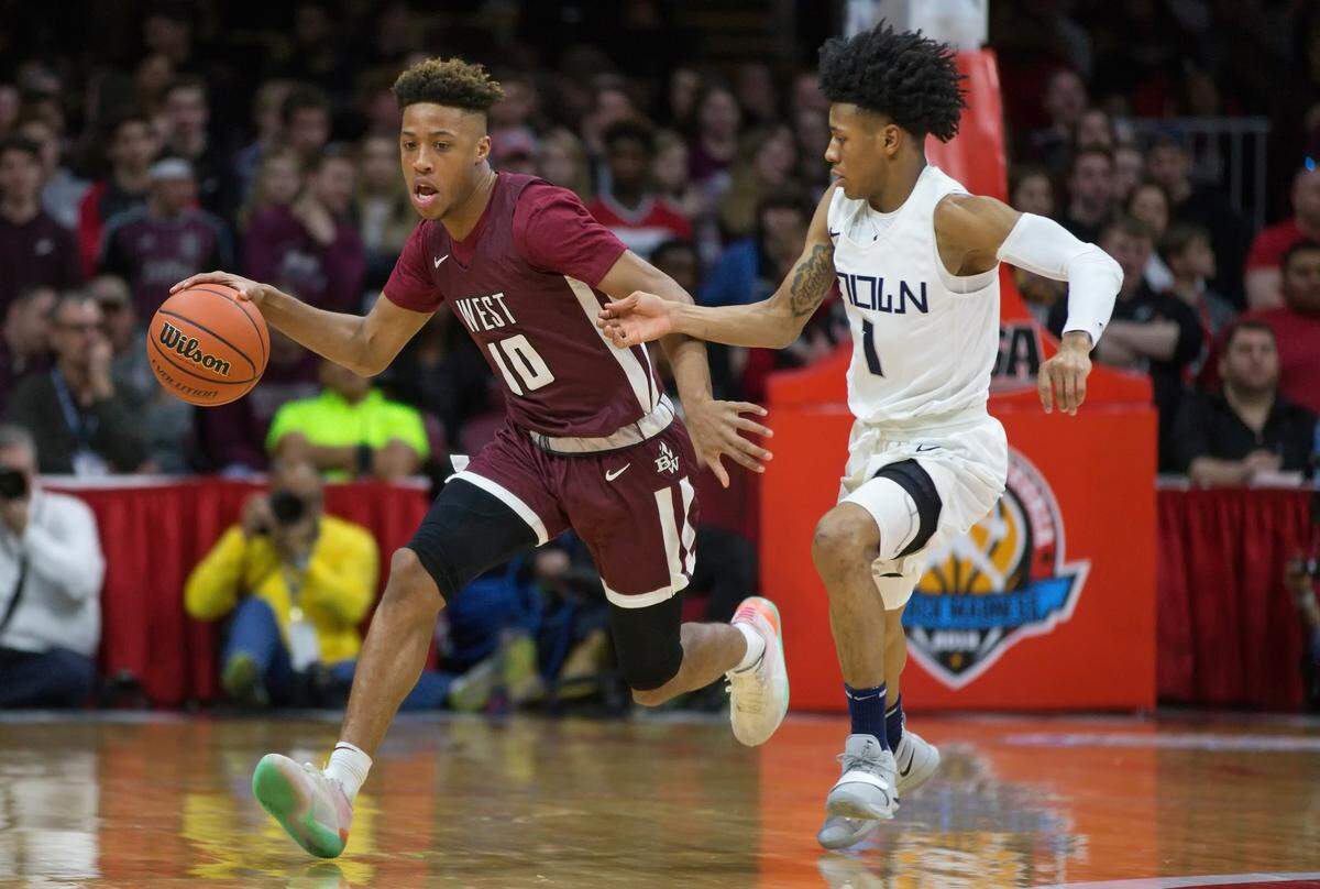 Belleville West Tommie Williams drives against Evanston Jaheim Holden during Saturday’s Class 4A State State Championship game at Peoria Carver Arena.