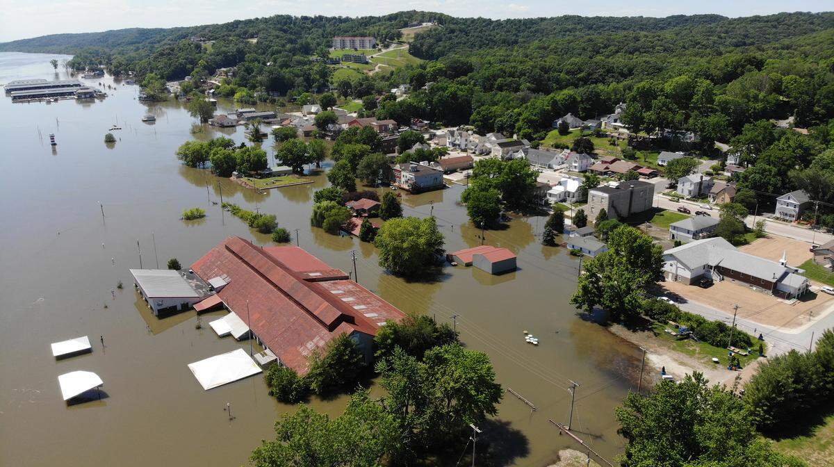 The real damage came from the length of the flood, which closed The Loading Dock, at left in photo, for more than 70 days. Every time the river started to go down, the move-in process would start, only to be halted by the river rising again.
