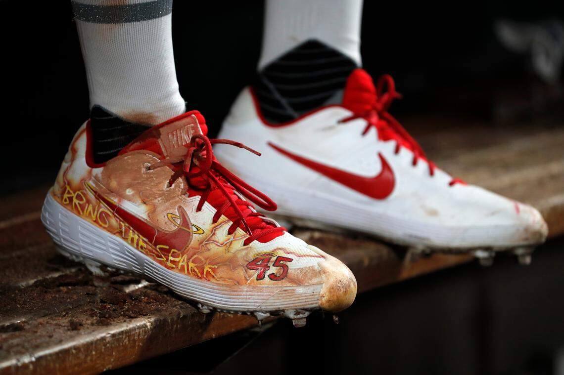 Cleats belonging to St. Louis Cardinals starting pitcher Jack Flaherty are seen as he sits in the dugout during the sixth inning of the team’s baseball game against the Colorado Rockies on Friday, Aug. 23, 2019, in St. Louis. (AP Photo/Jeff Roberson)