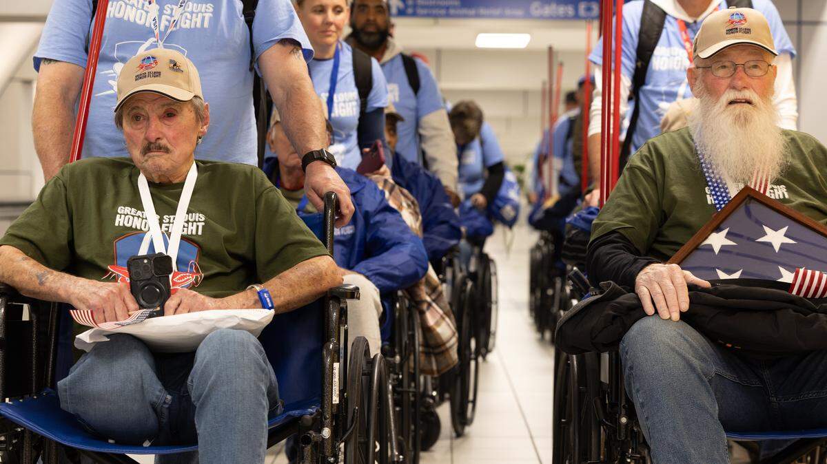 Veterans of the Greater St. Louis Honor Flight line up after disembarking from their plane to go through the airport in a kind of “parade,” being greeted by their families and supportive onlookers.