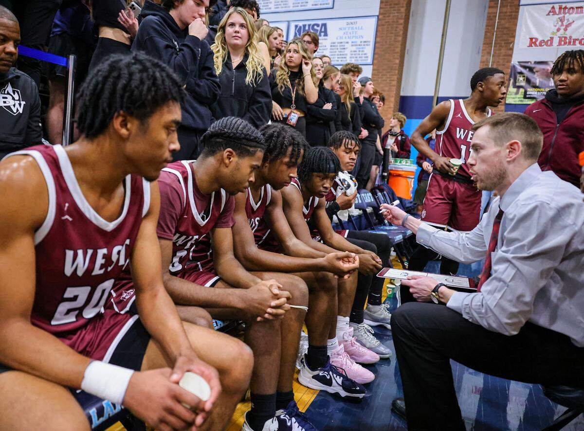 Belleville West coach Alex Schobert talks to his team during a timeout in Friday night’s game against Belleville East. The Lancers ultimately captured a 66-57 Southwestern Conference victory.