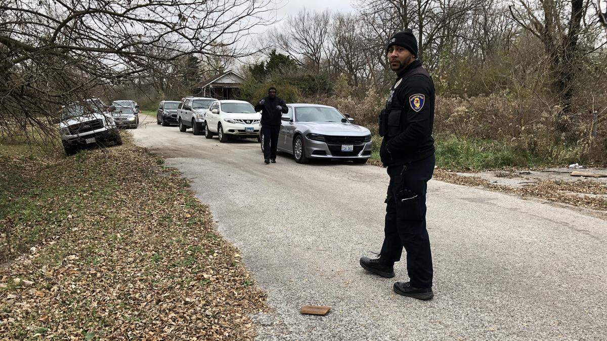 Police canvas a neighborhood after a skeleton was found in Washington Park on Monday.