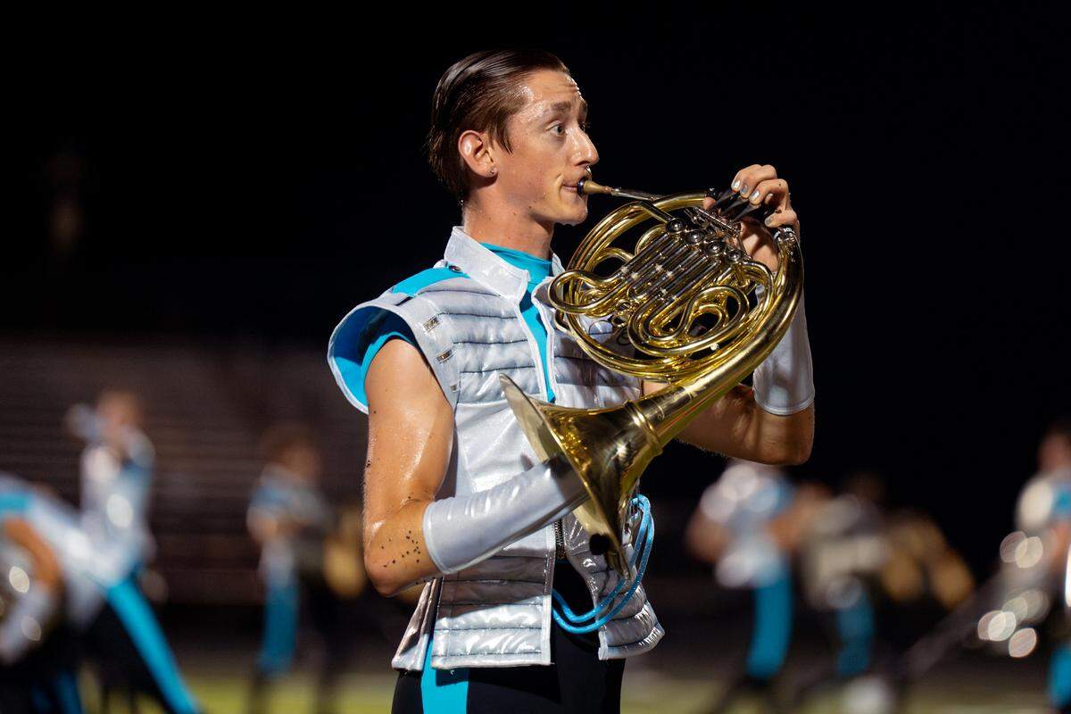A Boston Crusaders member performs a rendition of Sara Bareilles’ “Once Upon Another Time” on French horn during their show “BOOM” at Belleville West High School on Tuesday, July 22, 2025, in Belleville.