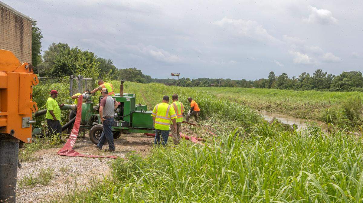 Workers set up a portable pump near State Street and Interstate 255 Thursday afternoon in East St. Louis. The pumps should help remove the water flooding homes in Parkside, Terrace Dr. and Mary Ave. that have been underwater since early Tuesday.