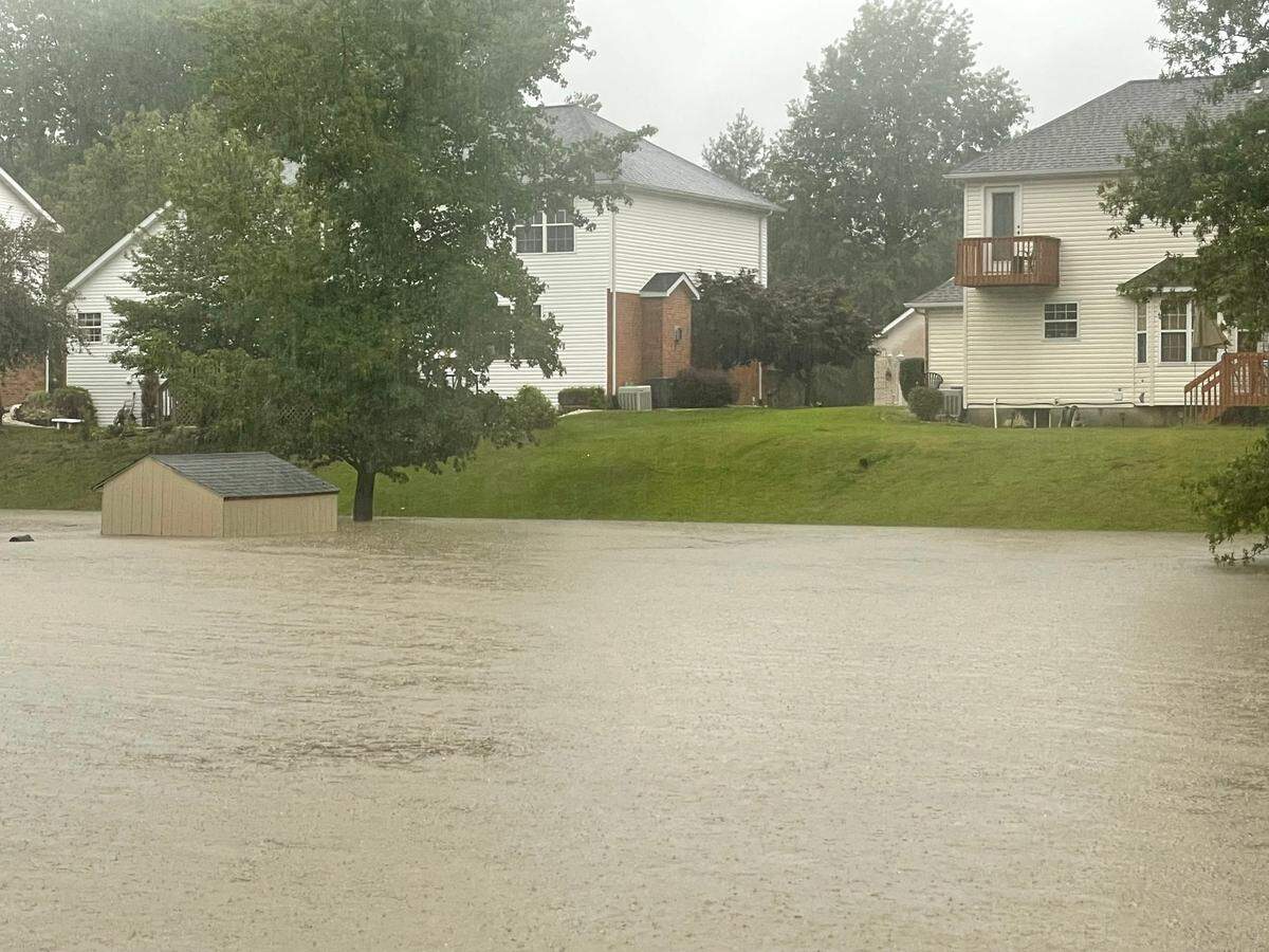 Water from record rainfall flooded Centennial Park in Swansea and backed up into yards on Creekside Drive.