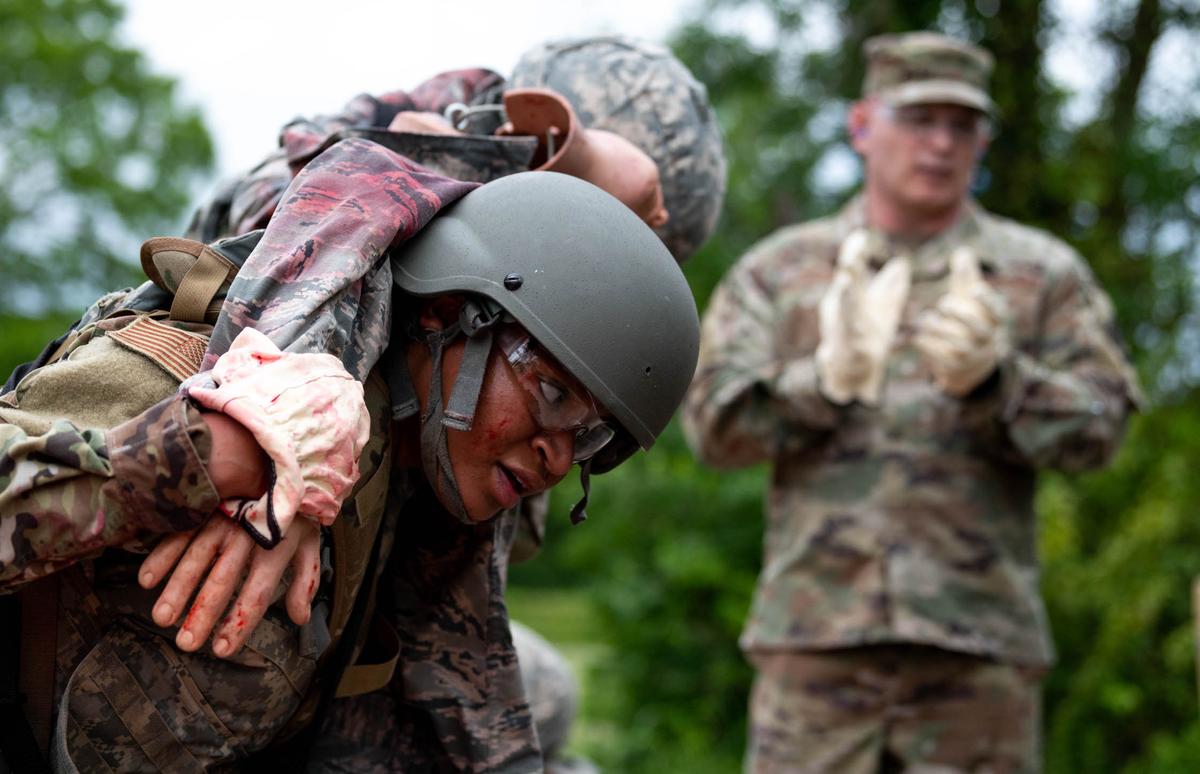 U.S. Air Force Javiah Brown, Communications Support Squadron cyber assurity vulnerability assessment technician, performs a carrying technique during the Warrior Airman Readiness program in the containment area on Scott Air Force Base. During the week-long course, Brown and 11 other Airmen took part in various training modules in one of the 375th Air Mobility Wing newest programs focusing on survivability, tactical combat casualty care and small team tactics.