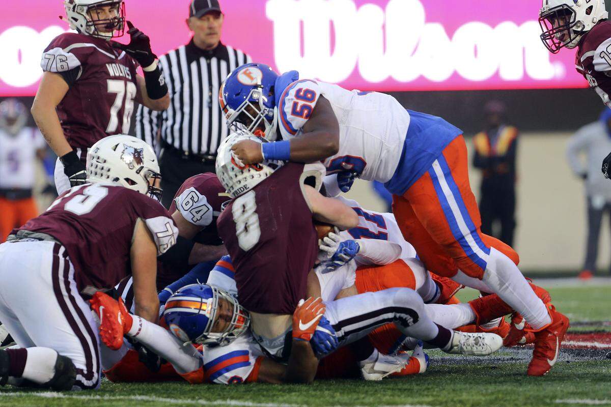 East St. Louis linebacker Kendrick Scarbrough stops Kyle Koelblinger during the IHSA Class 6A state championship game against Prairie Ridge in 2019, which the Flyers won 43-21. East St. Louis’ quest for another state title starts Saturday, Aug. 27, against Baltimore St. Francis at Tom Benson Hall of Fame Stadium in Canton Ohio