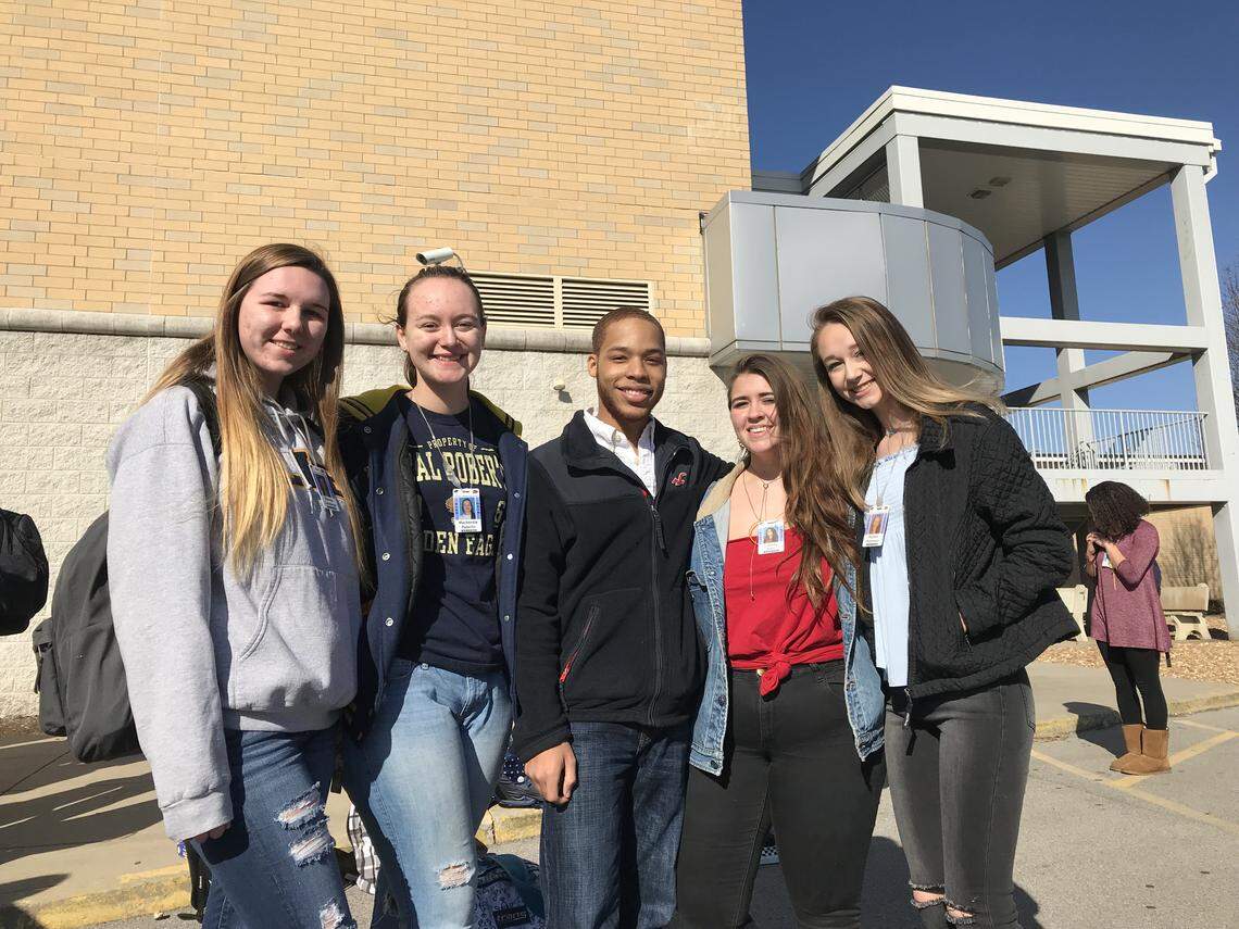 From right, O'Fallon Township High School juniors Brenna Cohlmeyer, Mackenzie Peterlin, Jordain Carpenter, Liberty Barr and Peyton Robinson joined the roughly 50 students who walked out of classes at 10 a.m. for 17 minutes as a national protest to support the 17 people who died as a result of a school shooting in Parkland, Fla.