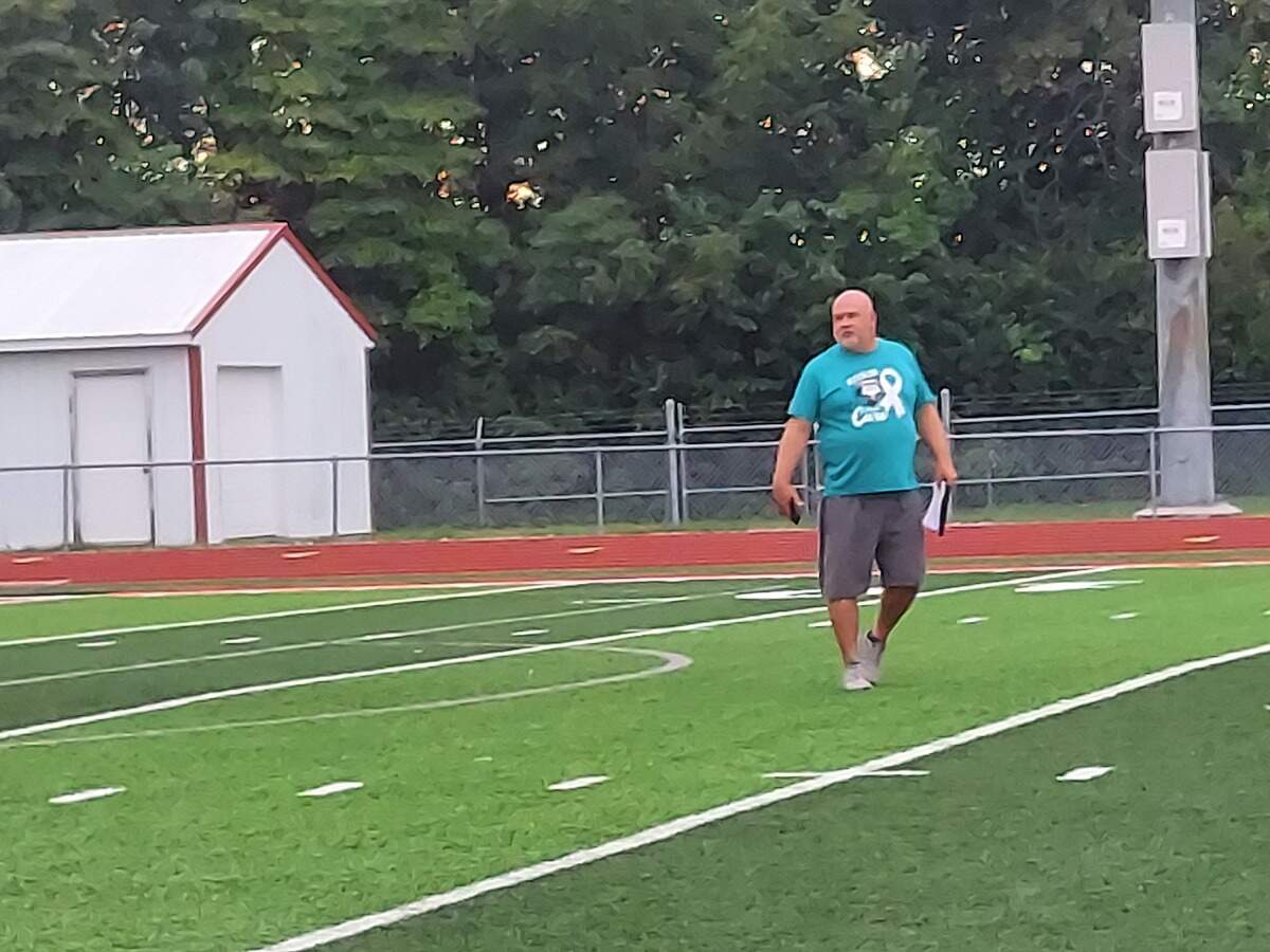 Highland boys soccer coach Jay Robertson leads the team through a conditioning drill during practice Tuesday, Aug. 15, at Highland High School.