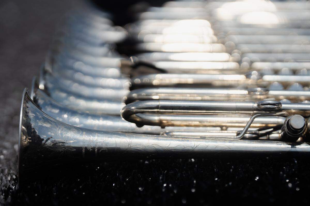 A stack of Boston Crusaders trumpets, engraved with the corps’ acronym, sits on the field on Tuesday, July 22, 2025, at Pattonville High School in Maryland Heights.