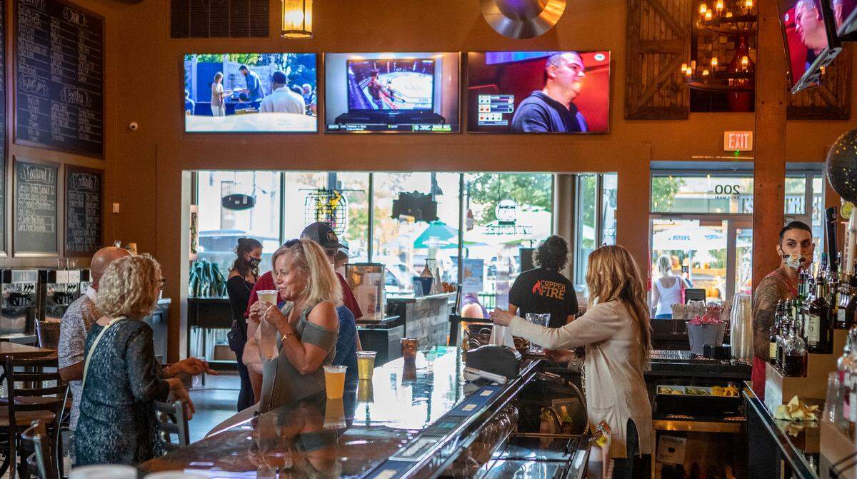 Customers start to gather inside Copper Fire restaurant and bar in downtown Belleville on Oct. 9, when Illinois lifted “resurgence mitigations” related to COVID-19 and allowed indoor dining to resume.