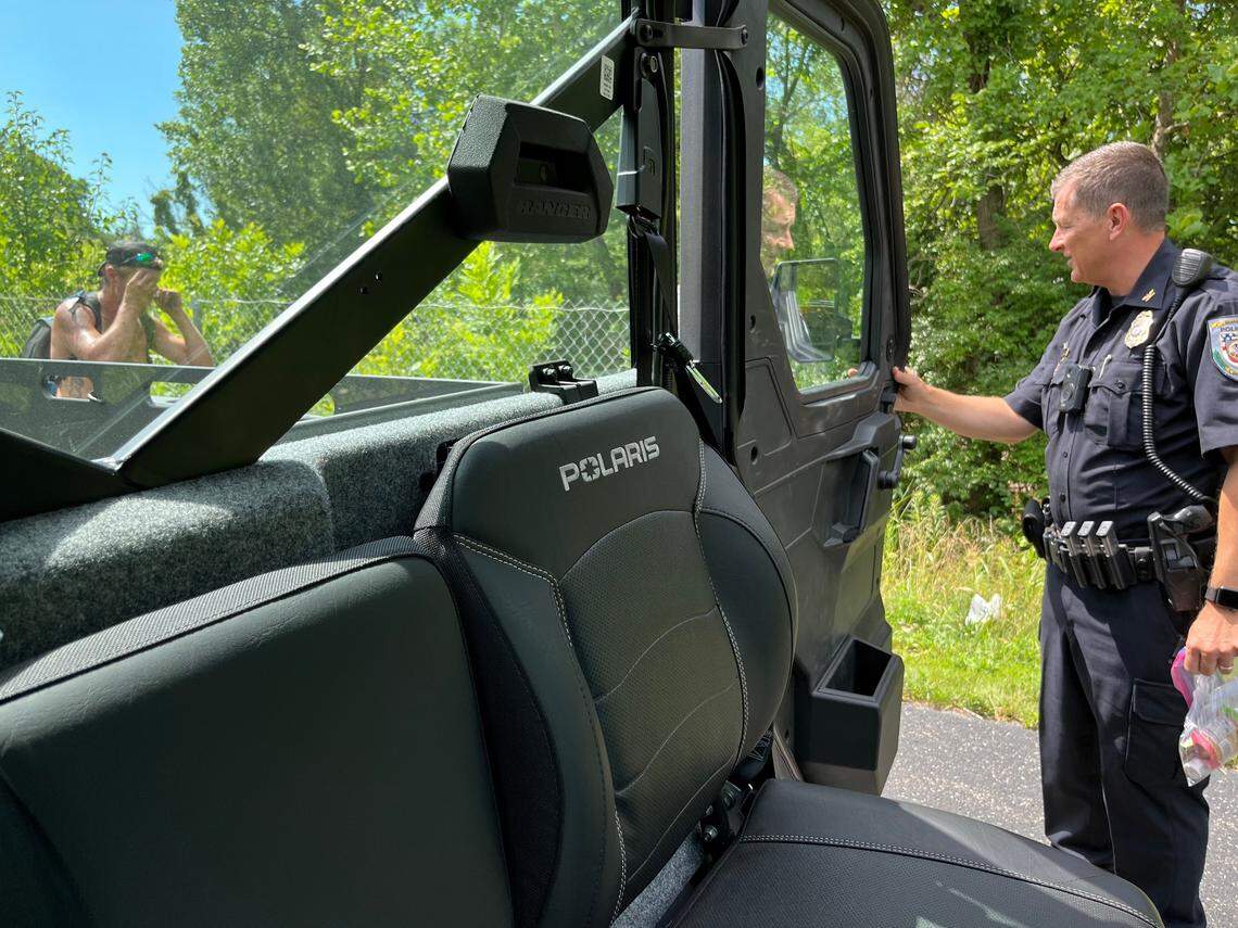 Swansea Police Chief Matt Blomberg talks to an unidentified man staying in an illegal camp along MetroBikeLink Trail last year. The man turned down supplies and promised to move.
