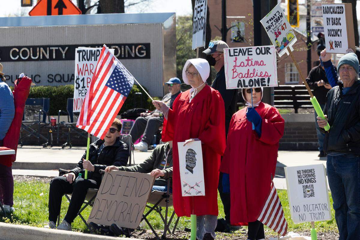 Some No Kings protesters in front of the St. Clair County Courthouse in Belleville on Saturday were dressed as characters from the dystopian TV series “The Handmaid’s Tale.”