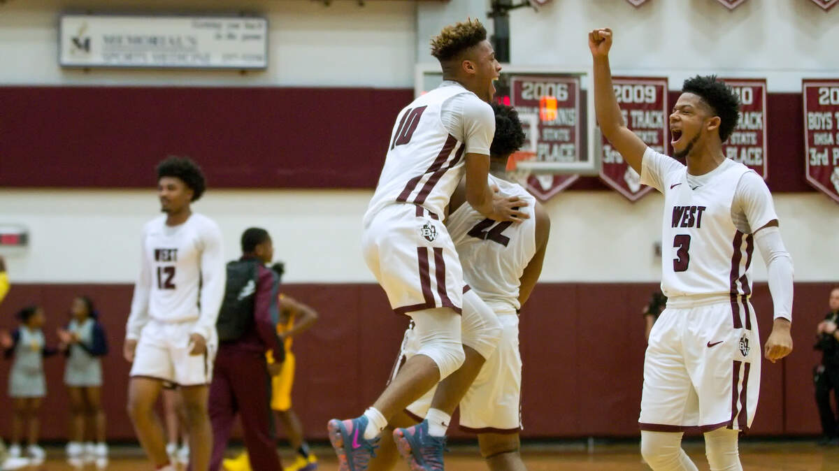 Belleville West Lawrence Brazil III celebrate their 74-73 win over Srpingfield East during Saturdays basketball game at Belleville West High School.