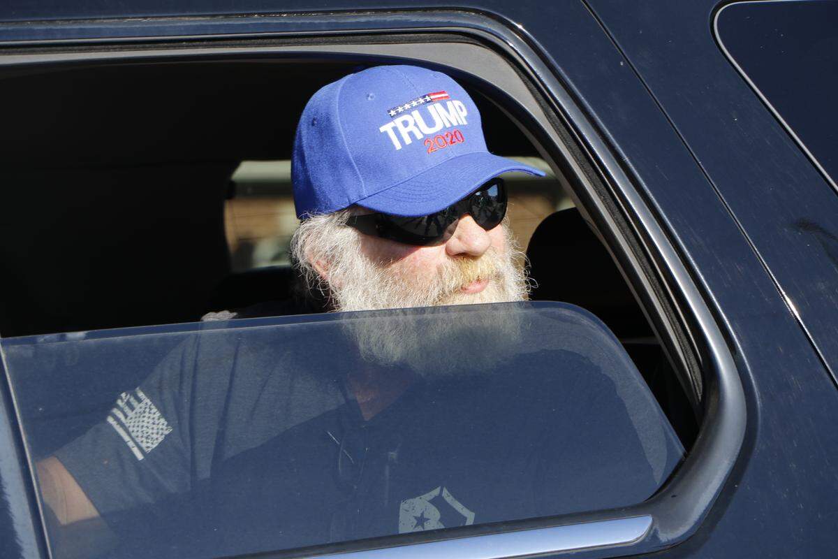 A man wearing a Trump hat looks out his car window at Black Lives Matter marchers in Anna on June 4, 2020.