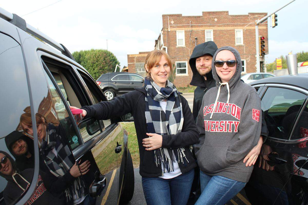 Erin Pugh, left to right, Billy Collins and his girlfriend, Jessica Jerashen, wait for the former Dandy Inn to be demolished on Thursday. Pugh and Jerashen worked at the Irish pub and restaurant.
