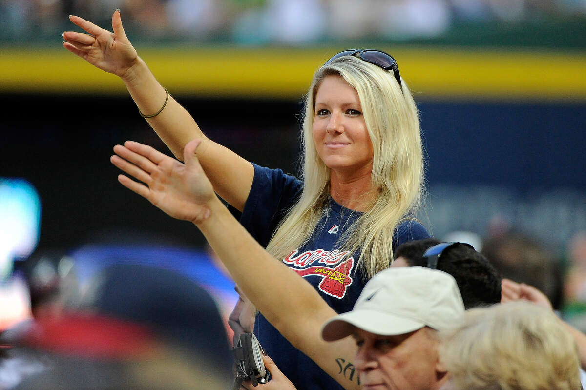 Atlanta Braves fans do the tomahawk chop during the second inning of a baseball game against the Washington Nationals Friday, Aug. 8, 2014, in Atlanta. (AP Photo/David Tulis)