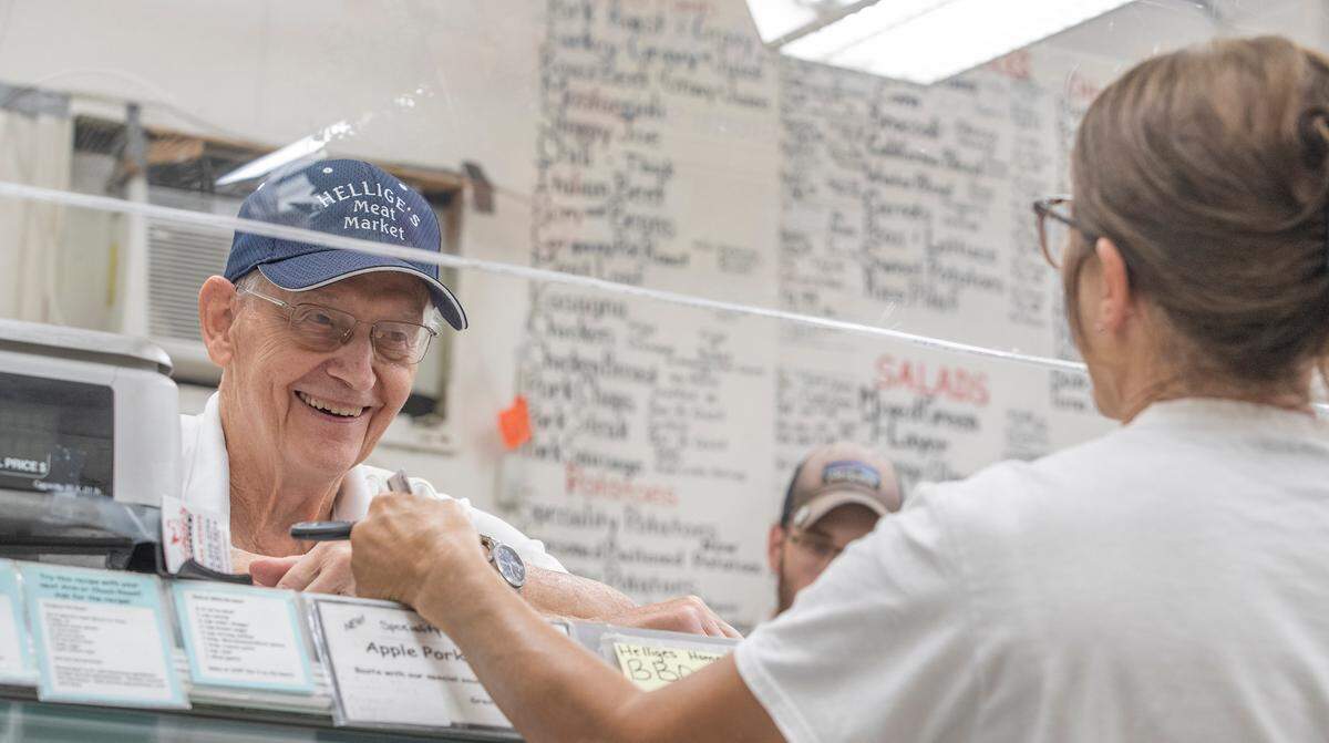 Rich Hellige talks to longtime customer Jackie Luebber at Hellige’s Super Market and Lockers in Breese on Wednesday, his last day in business. His family has owned the store for 87 years.
