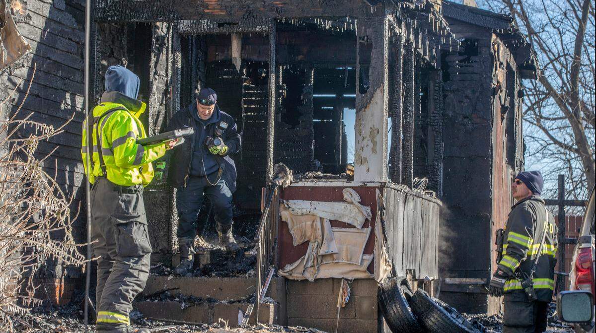 Belleville firefighters investigate a fire at a home in the 600 block of Rodenmeyer Street in Belleville. Firefighters found and rescued a “young child” from inside the home, but one resident was found already deceased at the back of the house.
