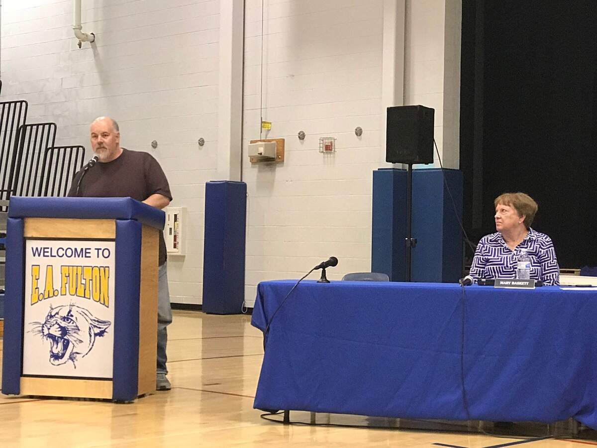 During the June 19 O'Fallon School District 90 board meeting at Fulton Jr. High, Tony Mast asks board member to "apologize" for recent controversial comments about transgender and Muslim students in released emails obtained through Freedom of Information Act requests. Right, board member Mary Baskett listens.