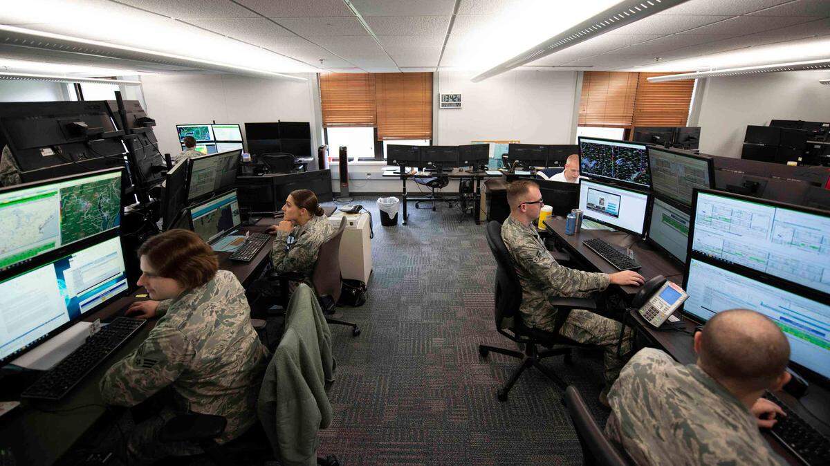 Airmen with the 15th Operational Weather Squadron work on forecasting for the Northeastern United States at Scott Air Force Base. These Airmen work with satellite imagery to determine when to send out severe weather alerts to military bases.