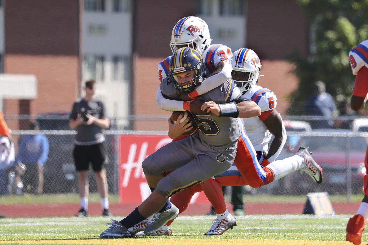 East St. Louis linebacker Dominic Dixon sacks O’Fallon quarterback Colt Michael during Saturday’s Southwestern Conference game. The Flyers rolled to a 60-21 victory.