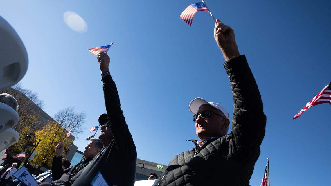 Veterans wave their flags during a performance of “America the Beautiful” during Belleville’s 26th annual Veterans Day ceremony on Nov. 11, 2024.