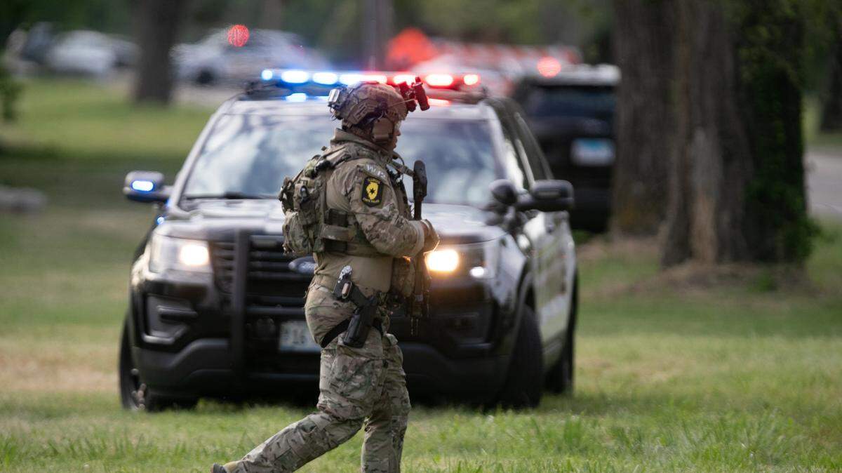 An Illinois State Police officer in riot gear approaches a house in Cahokia Heights during a standoff between a man and police on June 18, 2024.