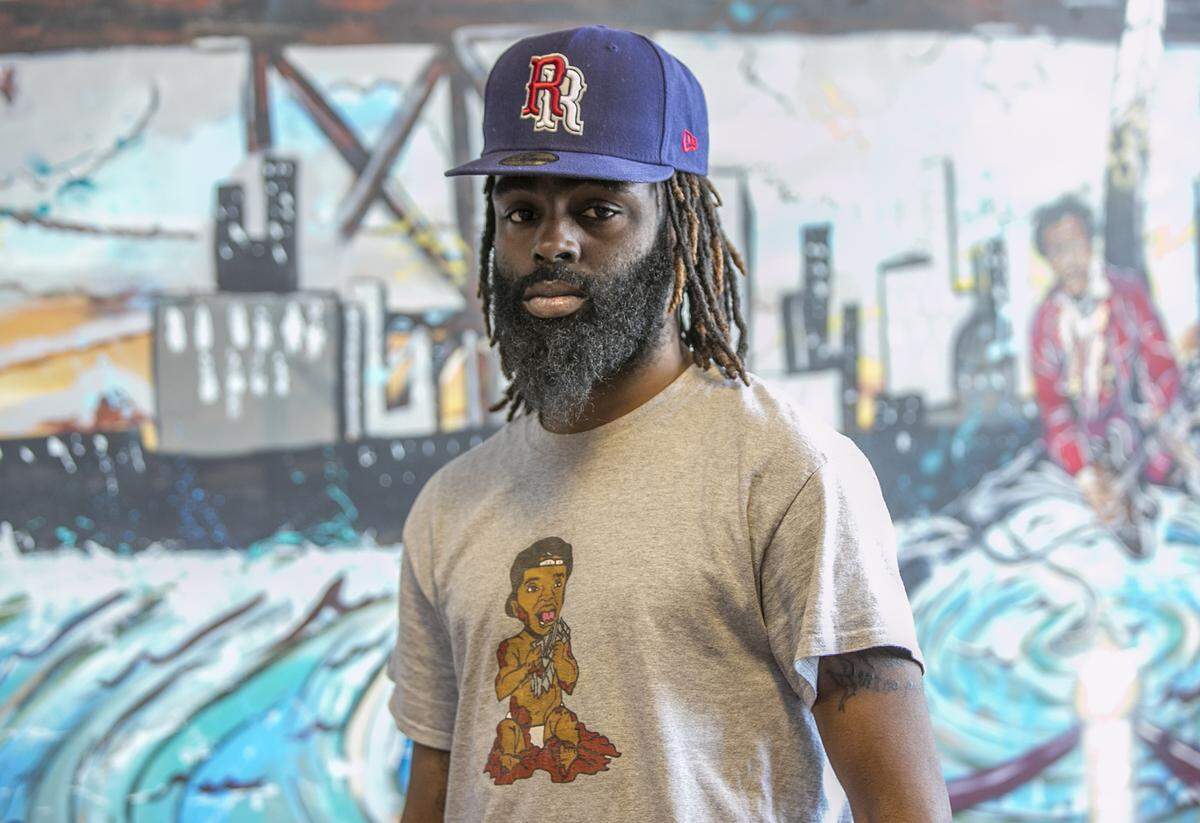 Fashion designer Arion Gilkey wearing his signature Mudd Brothers logo on his shirt.