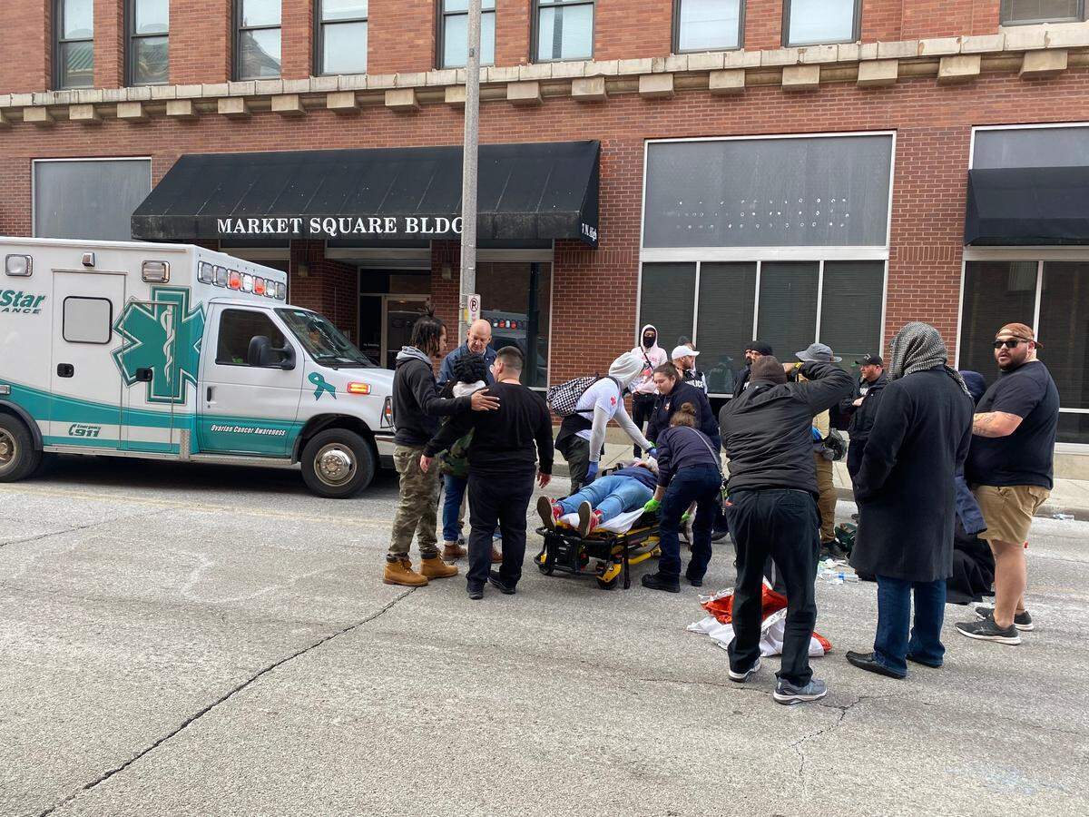 EMS workers attend to a young woman who was injured during a protest rally in downtown Belleville Saturday. Caption