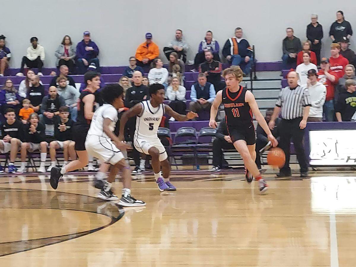 Highland junior guard Jake Ottensmeier looks to dribble past Mascoutah senior guard Quincy Hall (5) during a Mississippi Valley Conference basketball game Friday, Dec. 2, at Mascoutah High School. The Indians ultimately posted a 57-53 victory.
