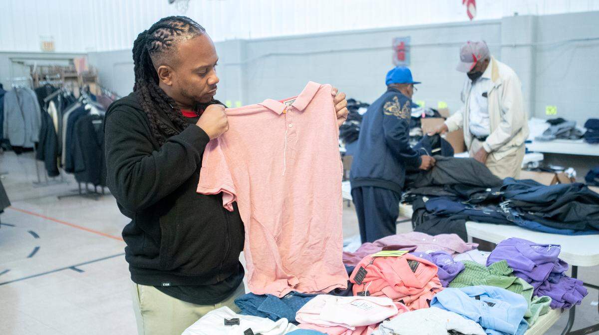 Volunteer, Terez Palmer, and others organize clothing in preparation for the  “Men Helping Men” suit & clothing giveaway this Saturday  October 29th from 10 AM to 4 PM at the Sunshine Cultural Arts Center 630 N. 59th Street, East St. Louis.&nbsp;  The event is sponsored by the 15th Street Baptist Church, the Male Involvement Group, and Sunshine Cultural Arts Center. Suit donations came from Jos. A. Bank. 
